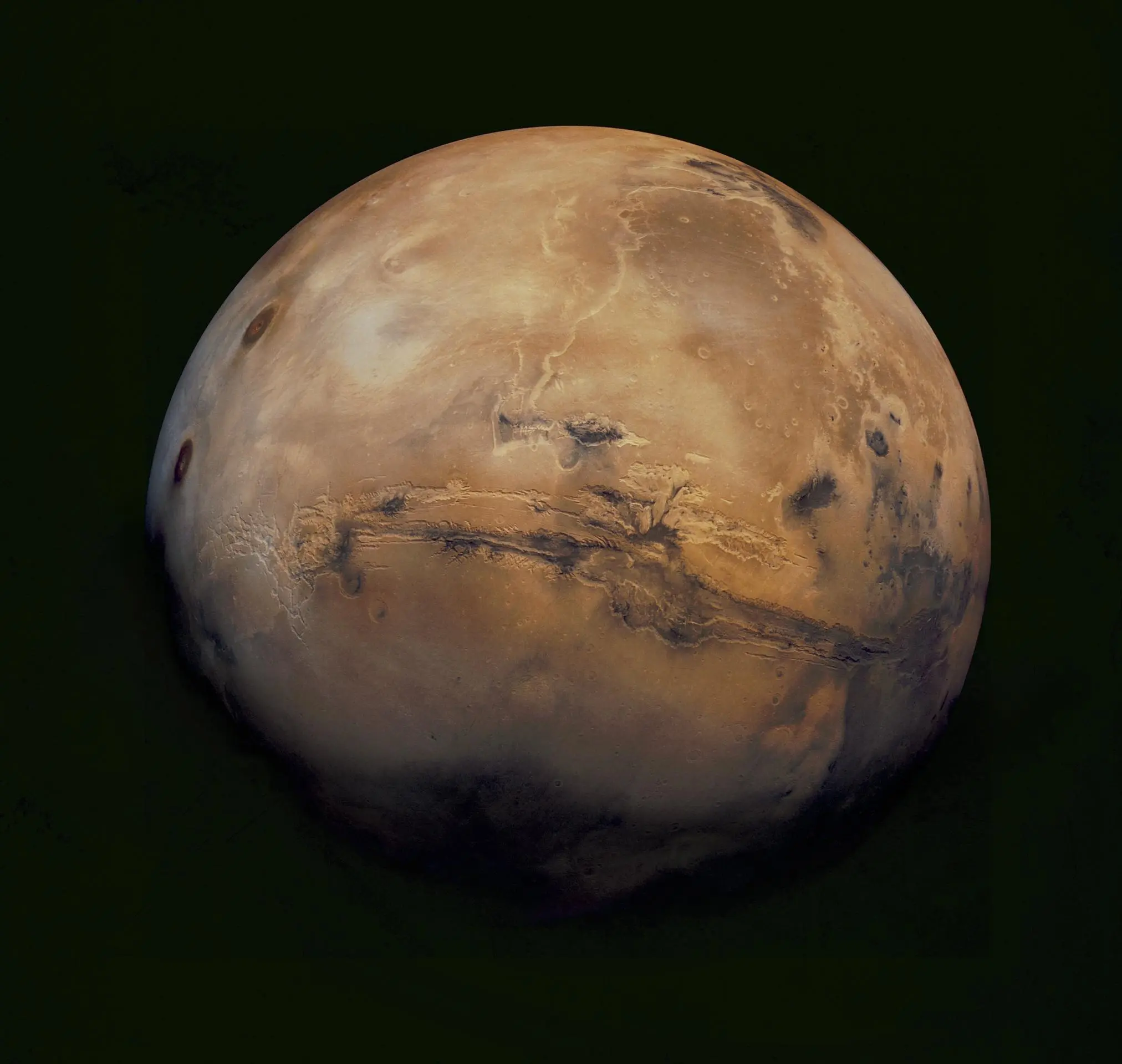 Spacecraft image of Mars showing a reddish rocky surface and polar ice cap.