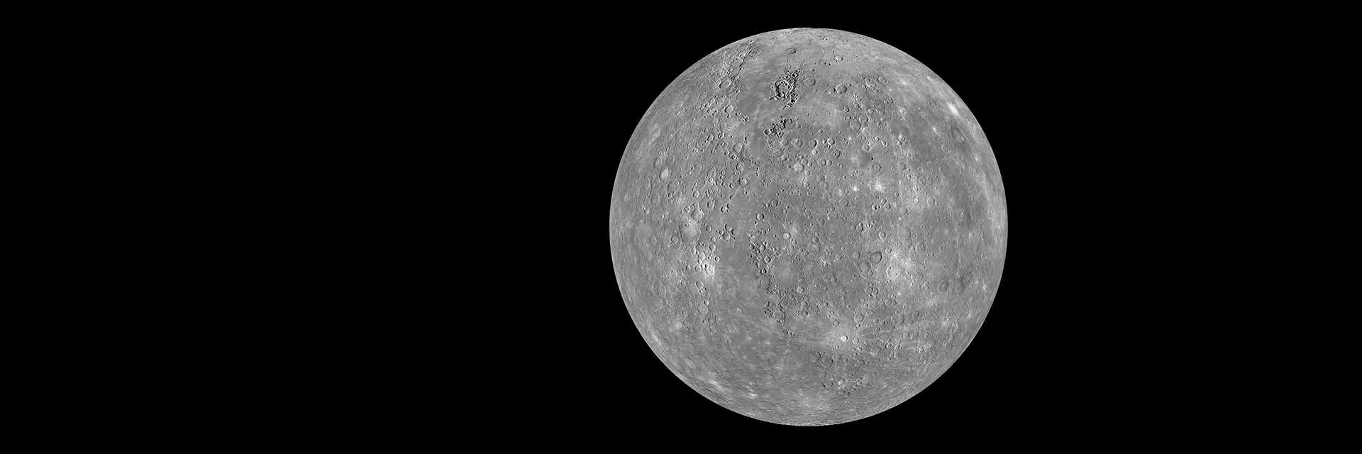 Spacecraft image of Mercury showing a gray, heavily cratered rocky surface.