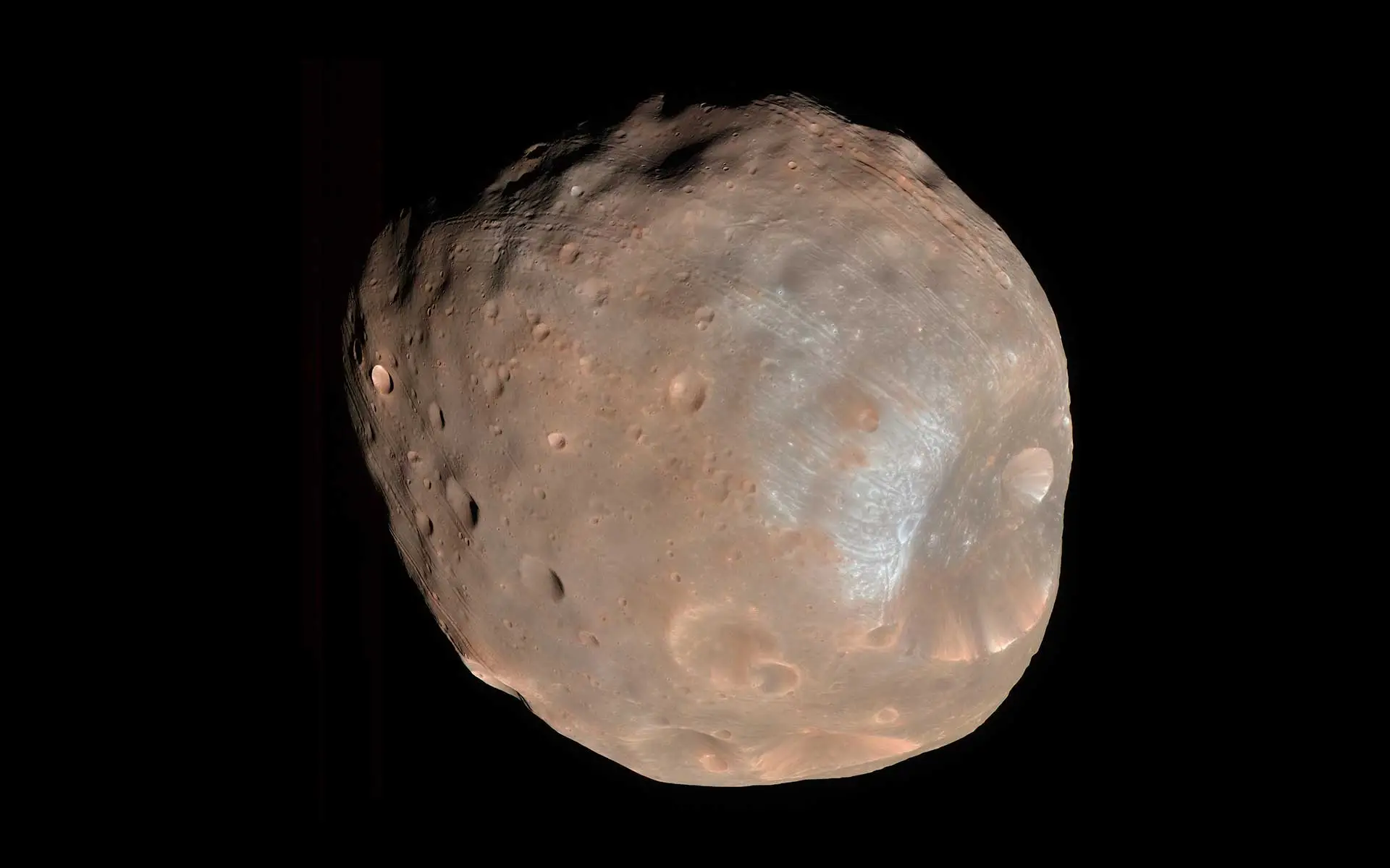 Image of Phobos showing an irregular, cratered, gray-brown surface.