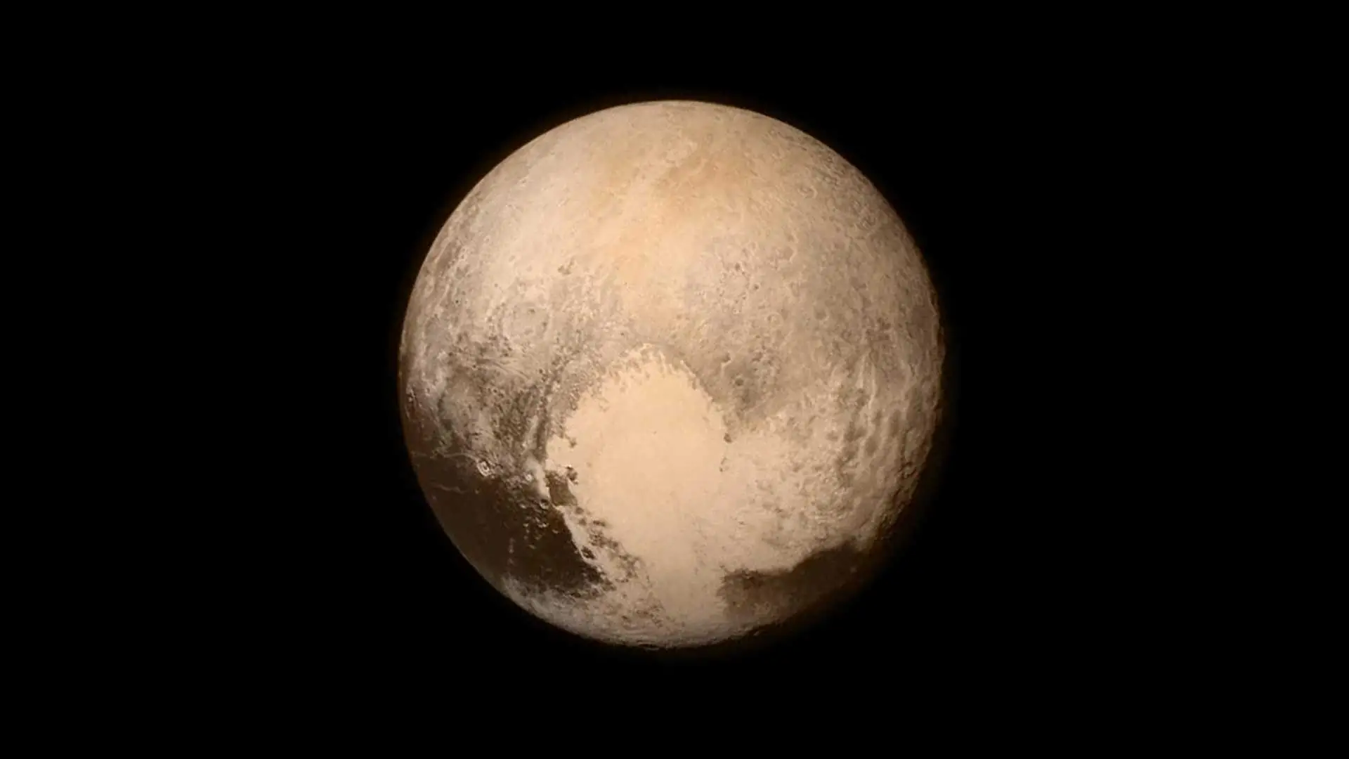 Image of Pluto showing a mottled surface with a bright heart-shaped region.