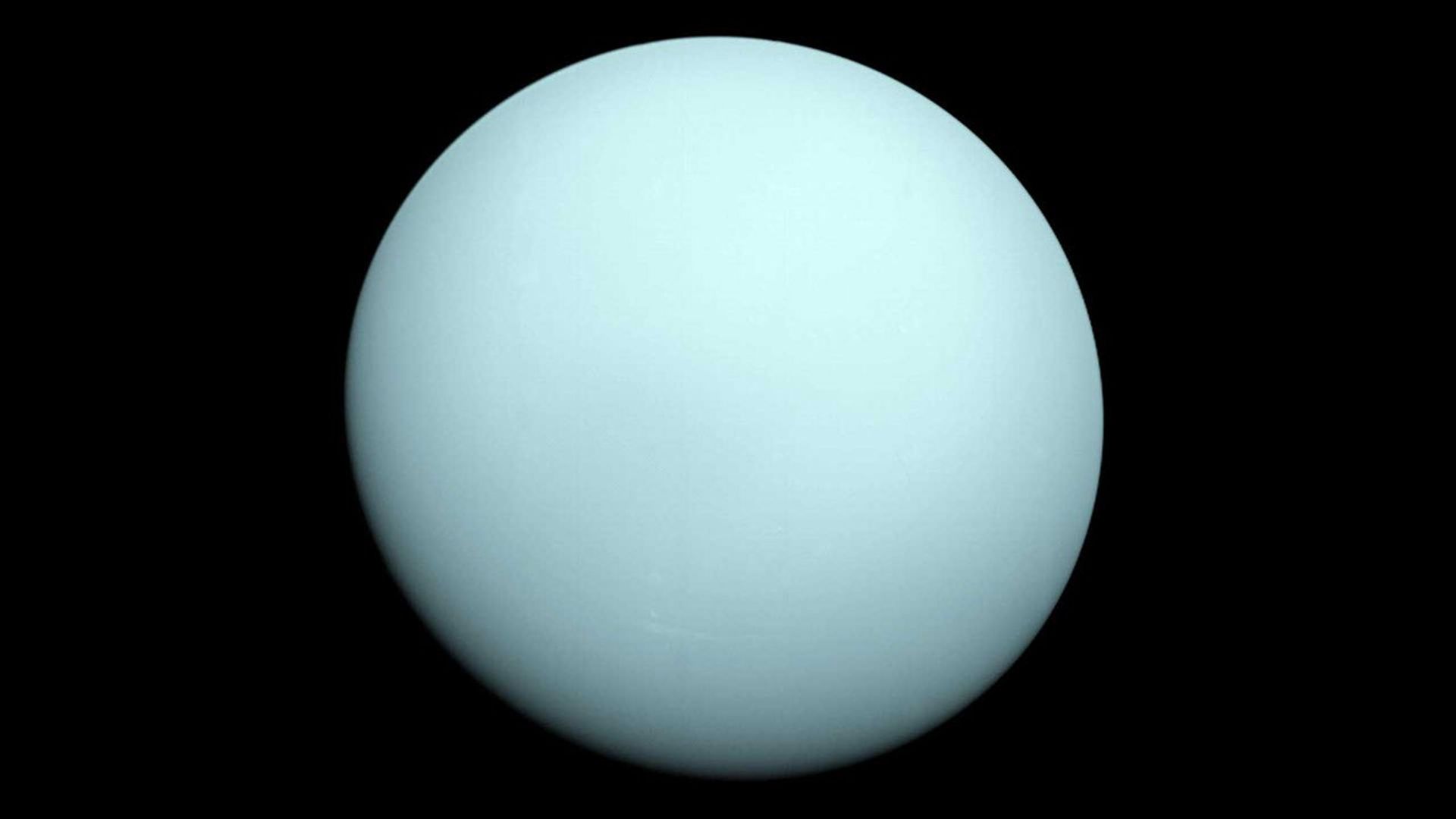 Image of Uranus showing a pale blue-green disk with subtle cloud features.