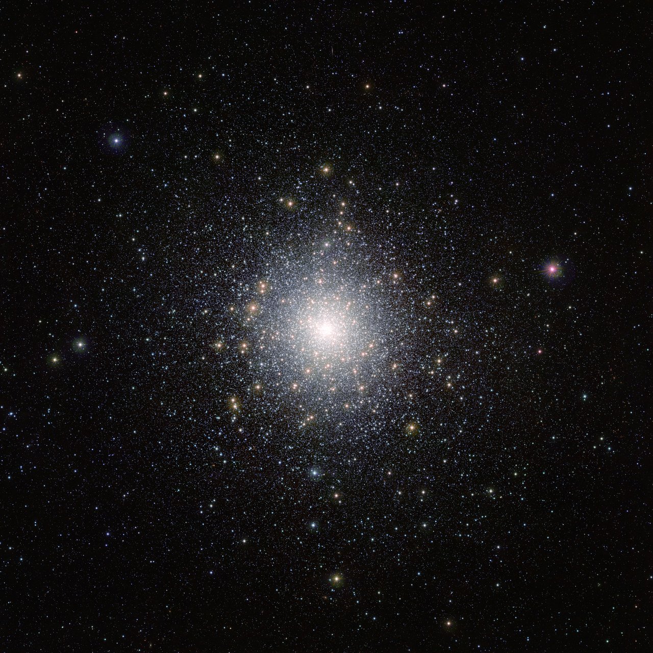 Wide-field image of the globular cluster 47 Tucanae. A dense bright core of many stars sits slightly left of center, surrounded by a gradually thinning halo of stars against a dark background.