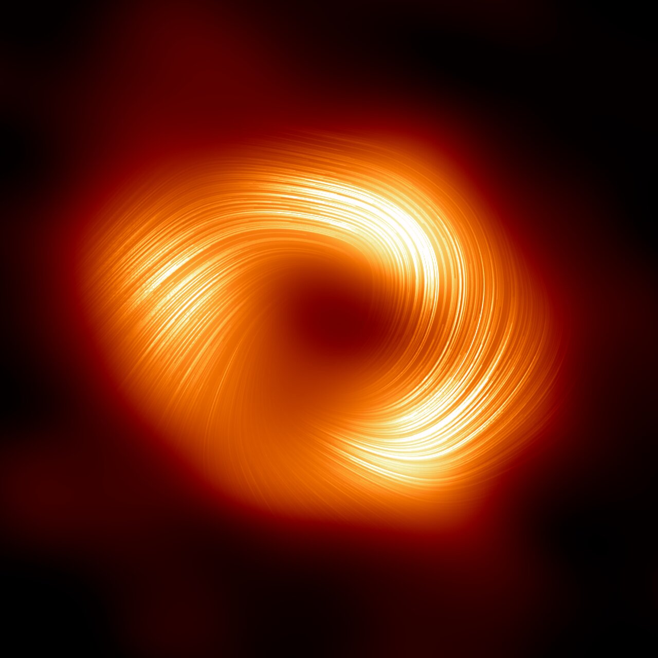 Event Horizon Telescope image of Sagittarius A star in polarized light. A bright orange ring surrounds a dark central shadow, with many fine curved line segments overlaid around the ring to mark polarization orientation.